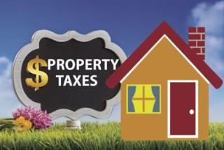 house with taxes sign