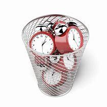 trash can full of clocks